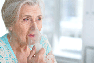 woman taking oxygen